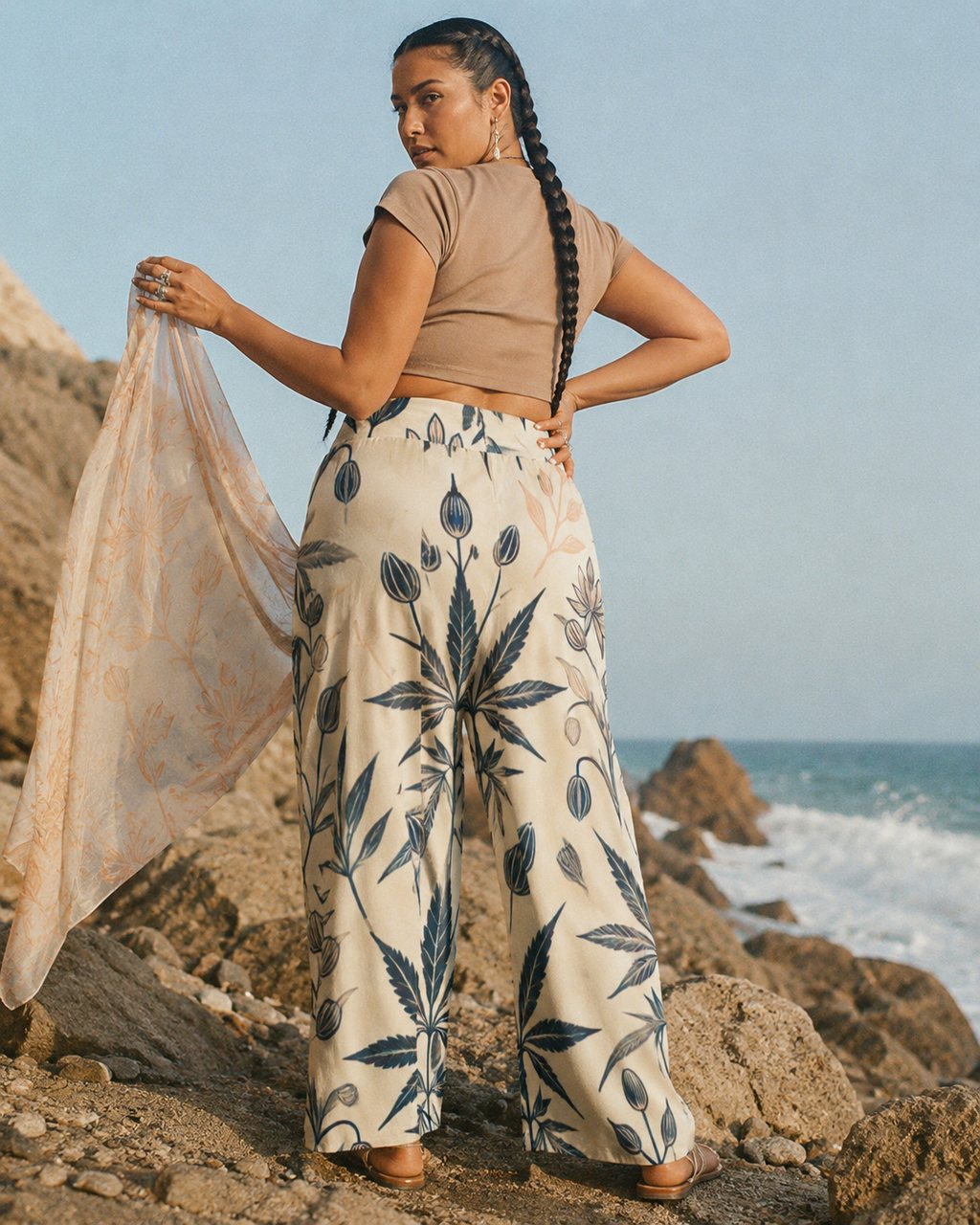 Soft sativa leaf print wide leg lounge pants, seated lifestyle shot on model