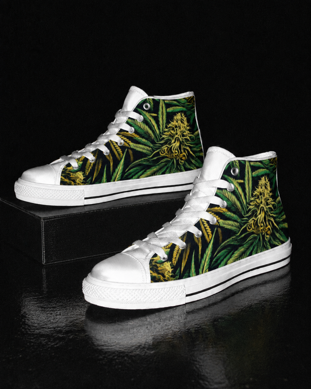 A pair of high-top sneakers with white rubber toe caps, laces, and soles, featuring a green tropical leaf and yellow flower print on the canvas uppers, displayed on a black reflective surface.
