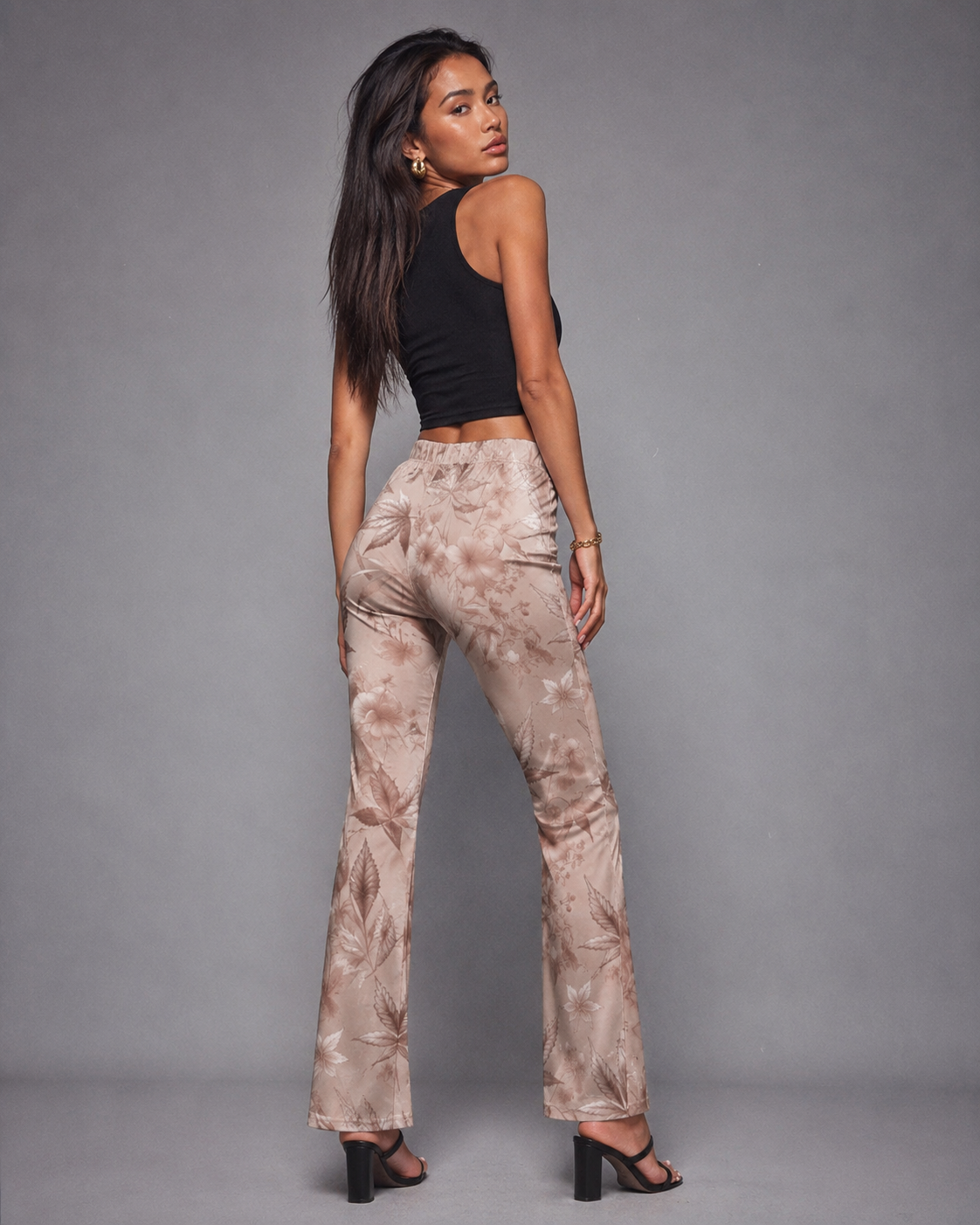 Rose graphic print flare pants, side view on model