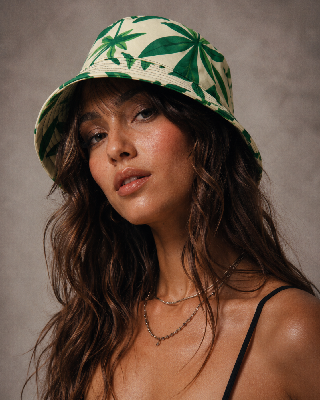 Green leaf print unisex bucket hat, back view showing brim detail