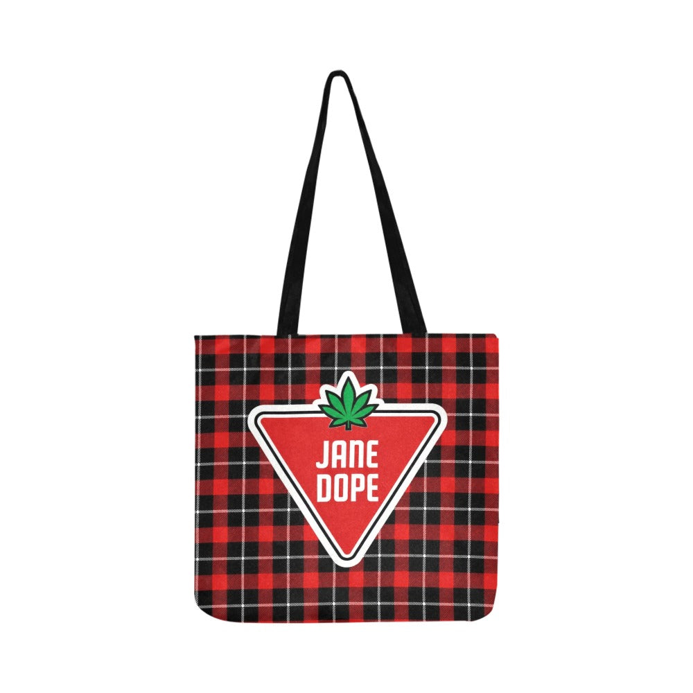 A red and black plaid tote bag with black shoulder straps, featuring a large red triangular 'JANE DOPE' logo patch with a green leaf on the front.