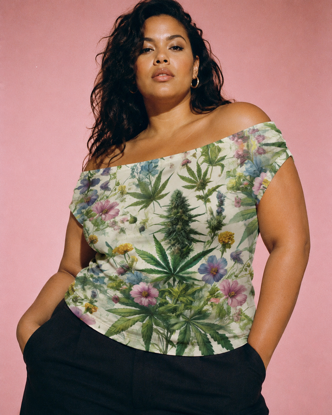 Woman wearing a floral and cannabis leaf patterned top against a pink background