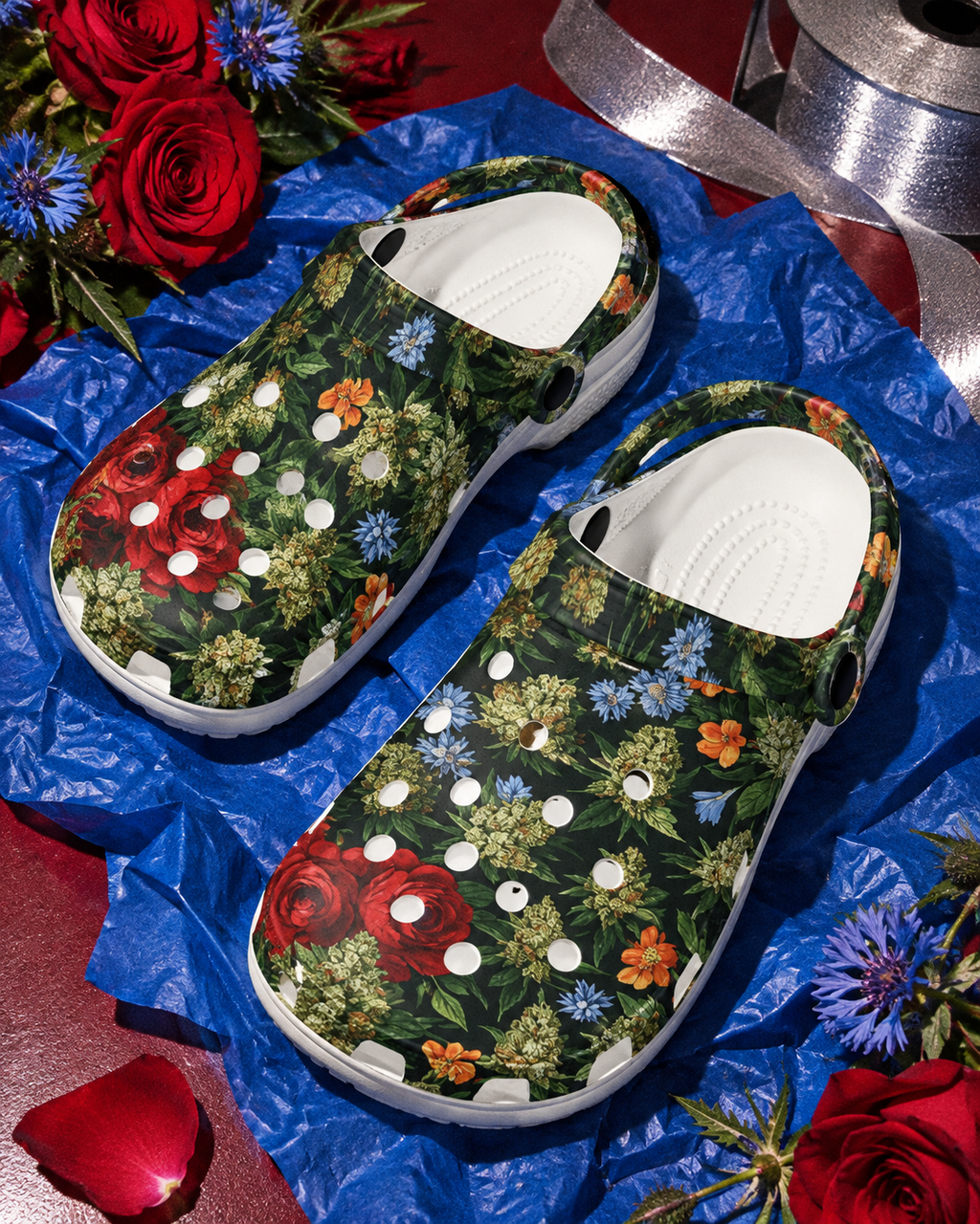 Pair of Bloom floral clogs on cobalt wrapping paper with roses