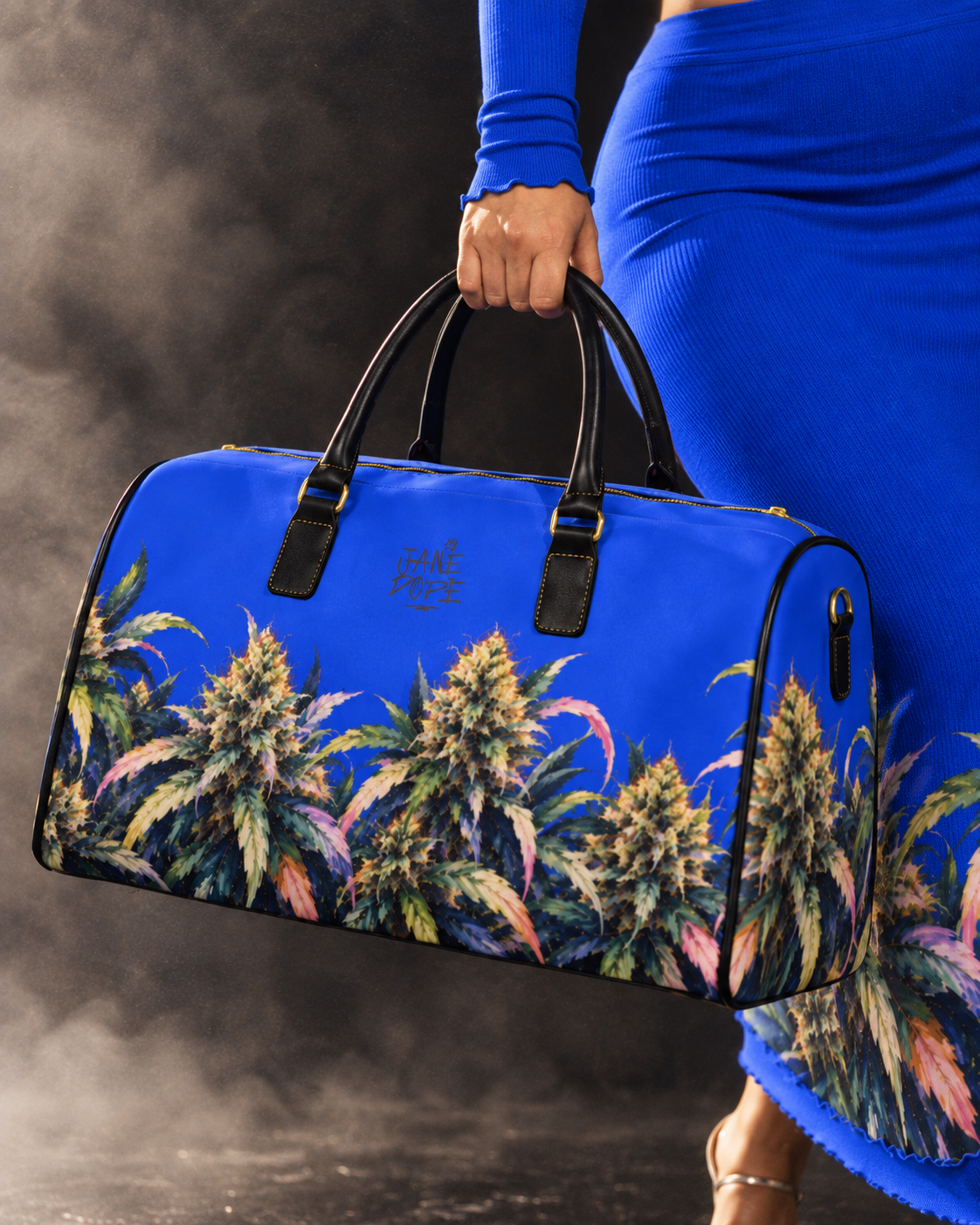 A person in a bright blue dress holds a blue duffel bag printed with colorful cannabis leaves. The bag has black handles and trim, and the brand name 'FAME PRICE' is printed on the front.