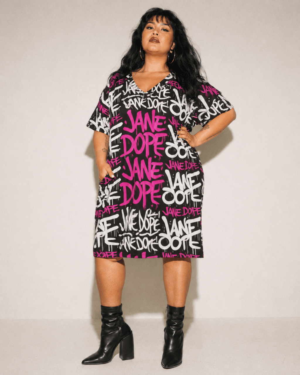 DANK! hot pink graffiti print pocket dress, seated lifestyle shot on model
