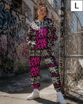 A model wearing a matching black and pink graffiti sweatshirt and jogger pants set, standing in an urban alleyway with graffiti walls and a chain-link fence. A size 'L' label is visible in the top right corner.
