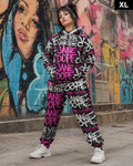 A model wearing a matching black, pink, and white graffiti-print hoodie and jogger pants set, standing in front of a colorful graffiti wall. The text 'XL' is visible in the top right corner.