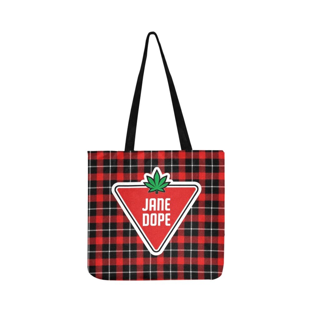 A red and black plaid tote bag with black shoulder straps, featuring a large red triangular 'JANE DOPE' logo patch with a green leaf on the front.