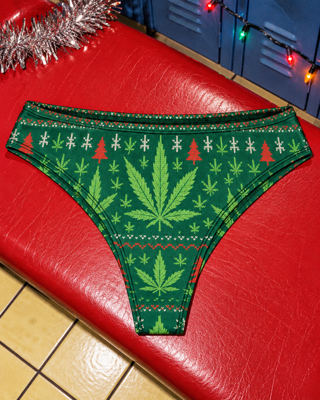 Festive Cotton Undies with green Herb holiday print laid flat on a red bench
