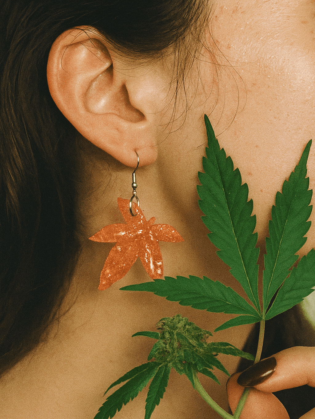 Jane Dope glitter moonstone cannabis leaf drop earrings, product shot on white background