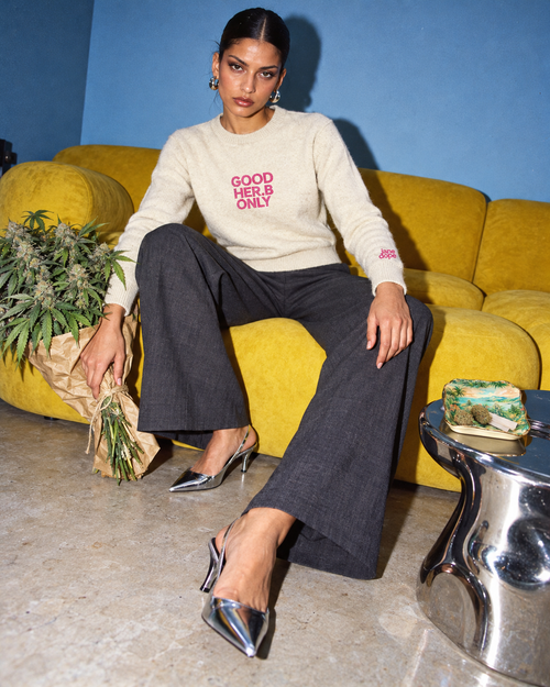 Jane Dope GOOD HER.B ONLY unisex knit sweater in Apricot. Thanks for bringing flowers: flash editorial on a blue-wall, yellow-sofa set.