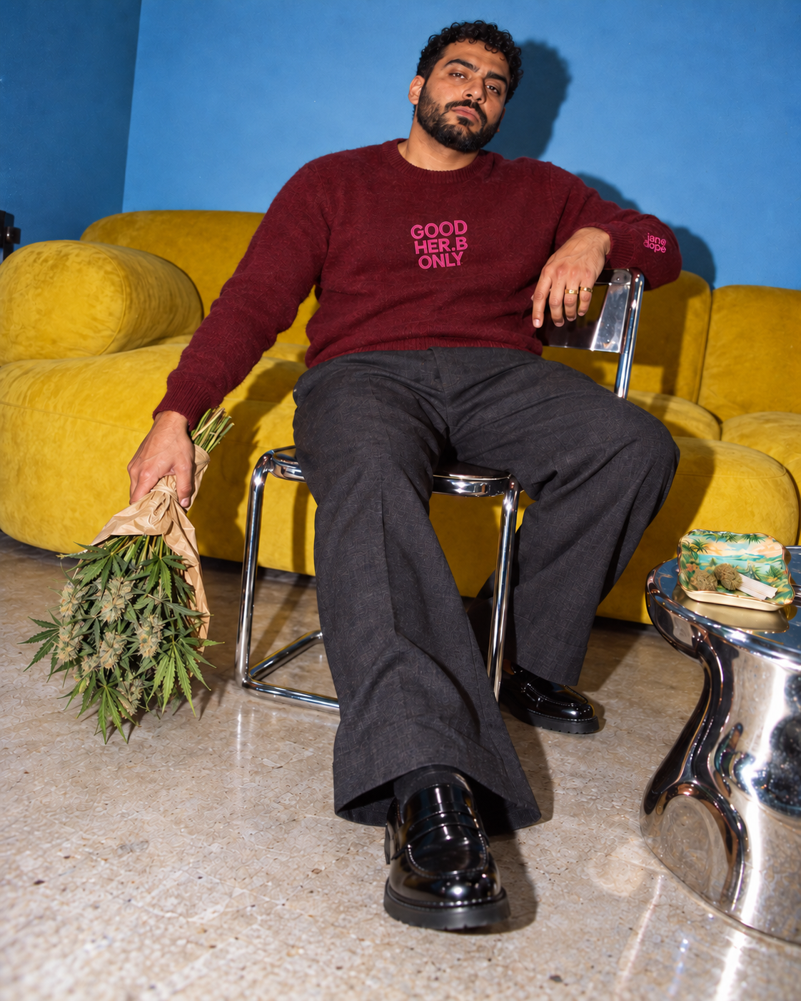 Jane Dope GOOD HER.B ONLY unisex knit sweater in deep burgundy. Guest of honour: flash editorial on a blue-wall, yellow-sofa set.