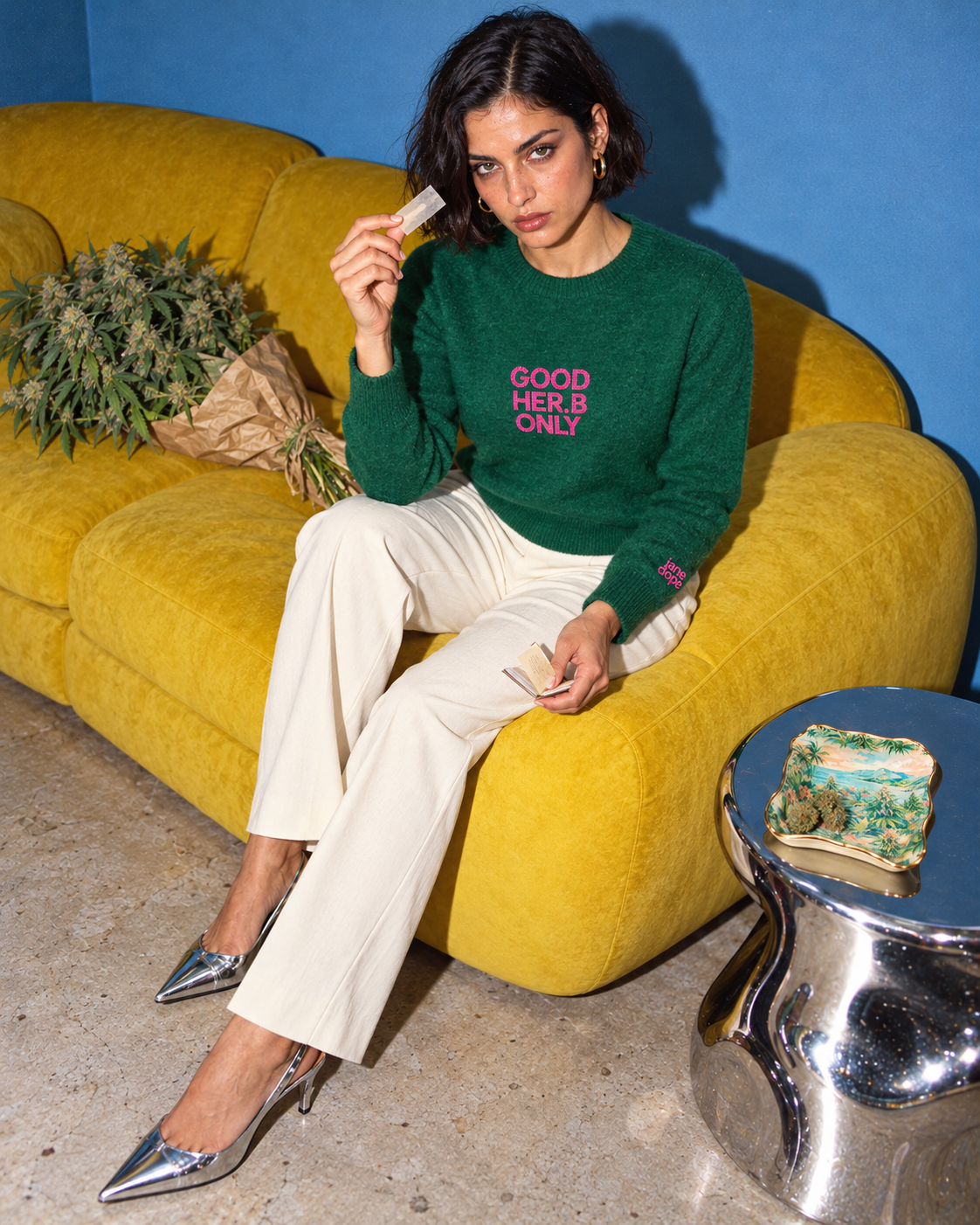 Jane Dope GOOD HER.B ONLY unisex knit sweater in Forest. Last paper: flash editorial on a blue-wall, yellow-sofa set.