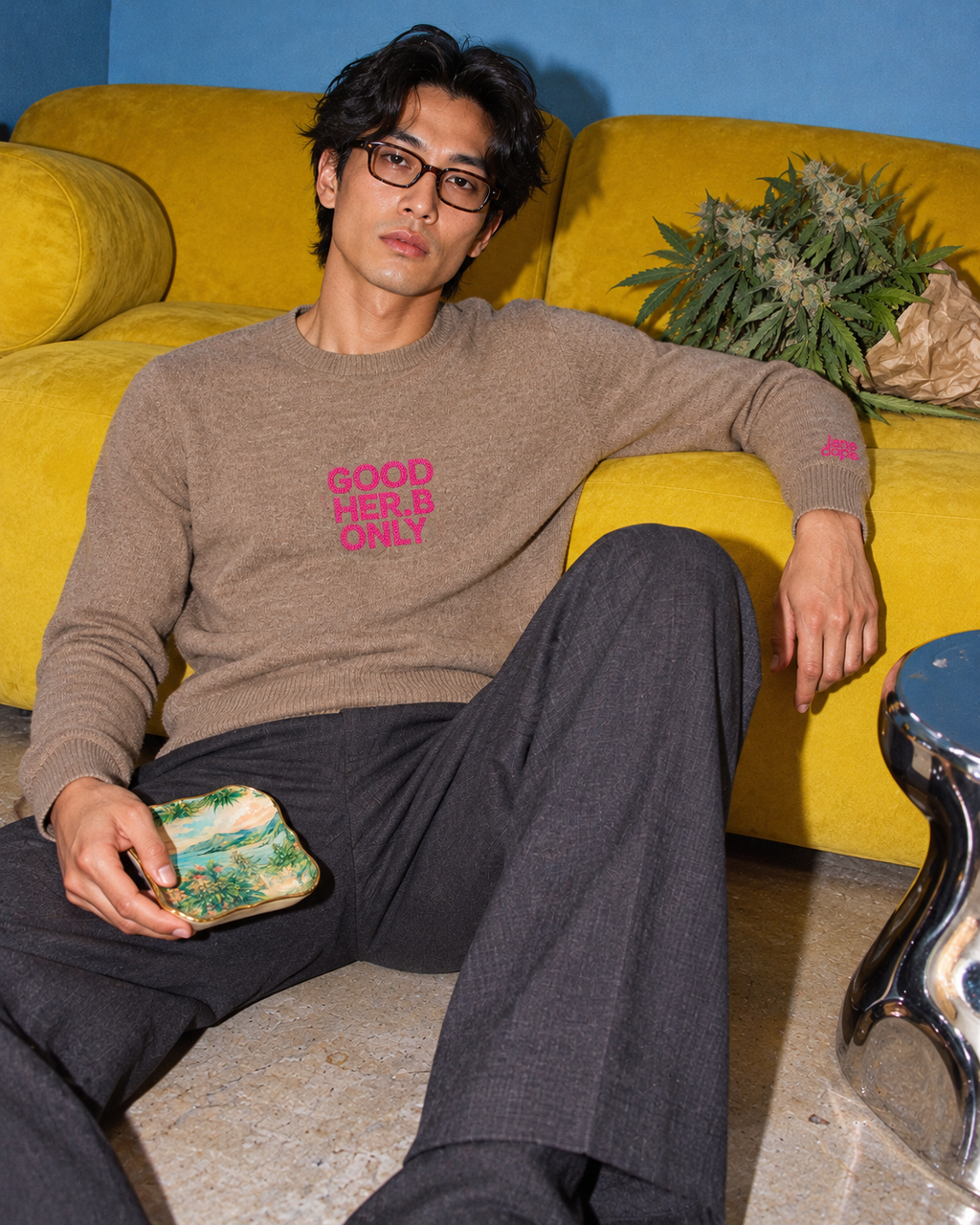 Jane Dope GOOD HER.B ONLY unisex knit sweater in Pebble. After the guests: flash editorial on a blue-wall, yellow-sofa set.