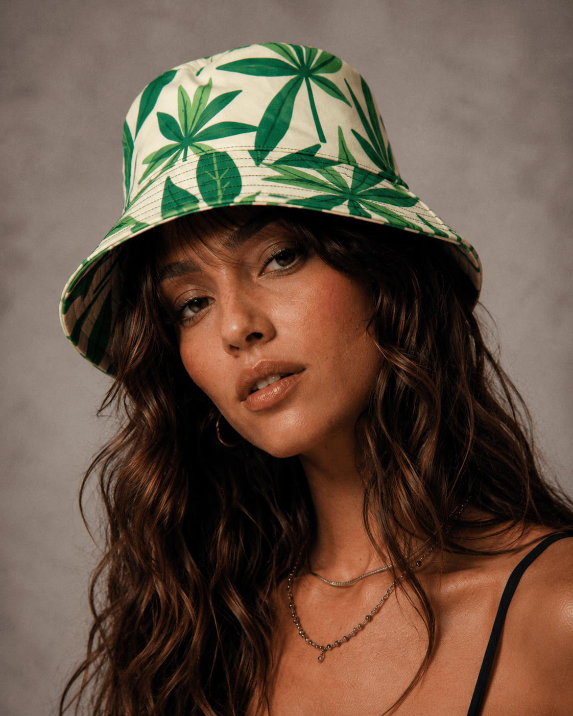 Jane Dope green leaf print unisex bucket hat, lifestyle front view on model