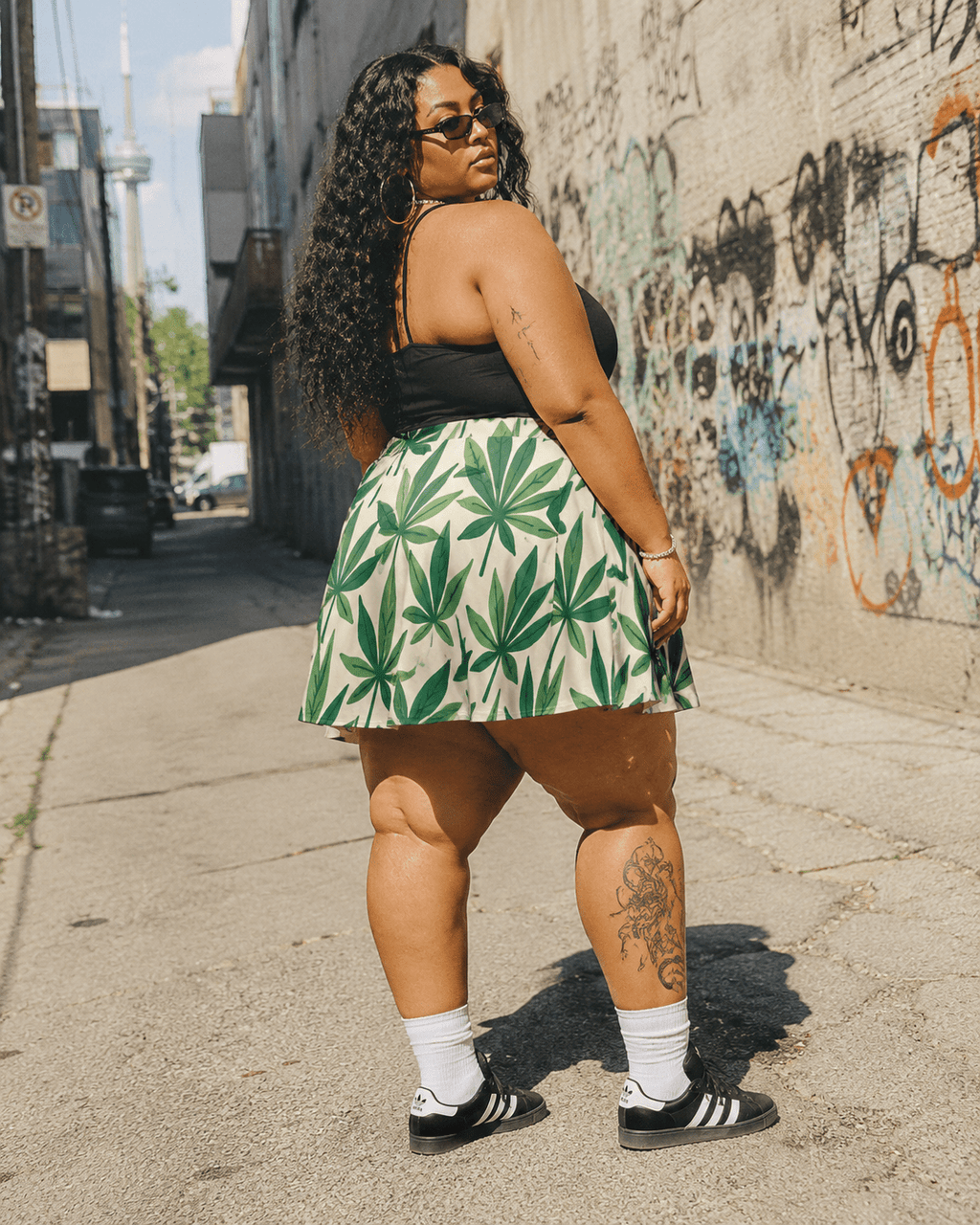 Leaf print skater skirt, seated lifestyle shot on model