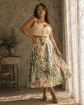 HER.B floral garden print pleated midi skirt, three-quarter view on model