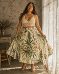 HER.B floral garden print pleated midi skirt, seated lifestyle shot on model