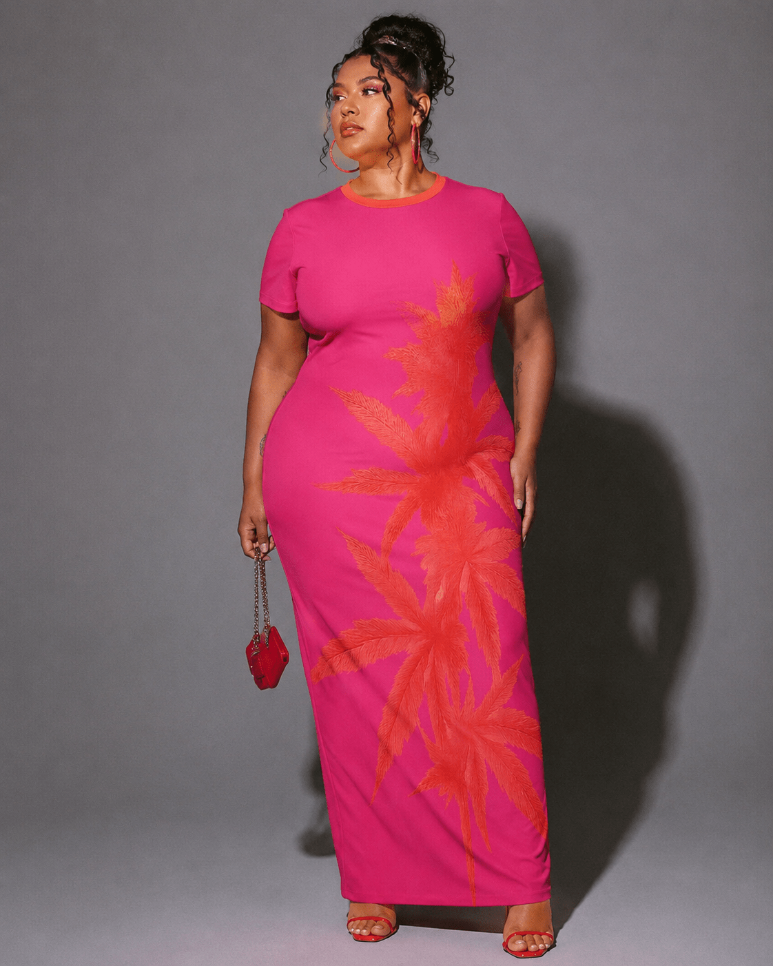 Pink tropical print bodycon dress, walking shot showing hem movement