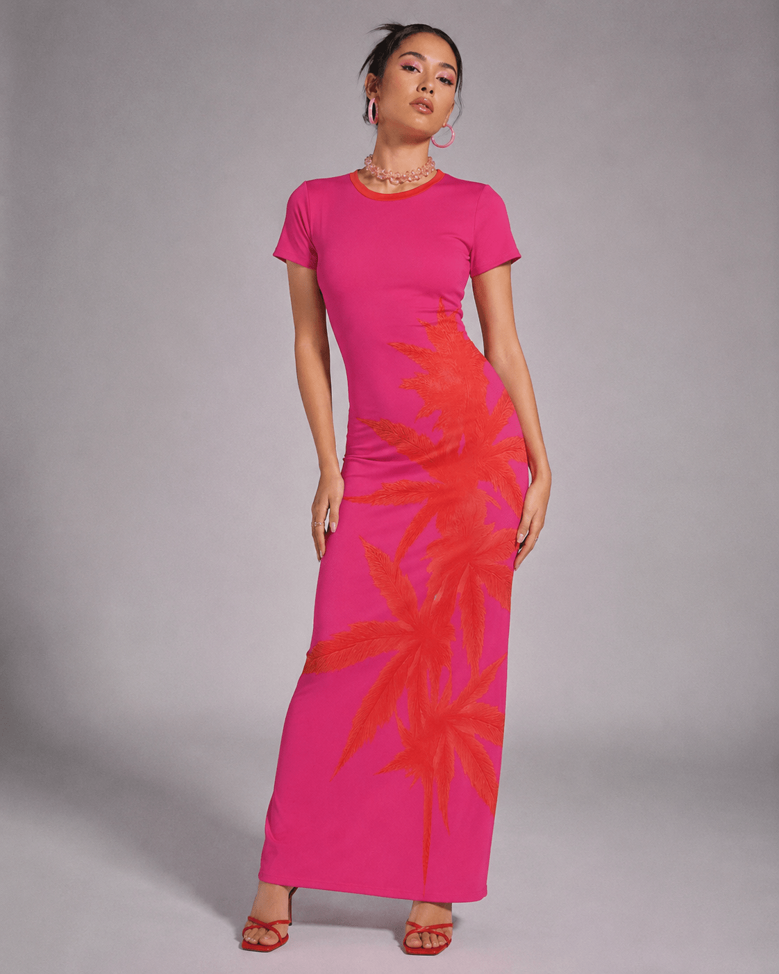 Pink tropical print bodycon dress, side view on model showing silhouette