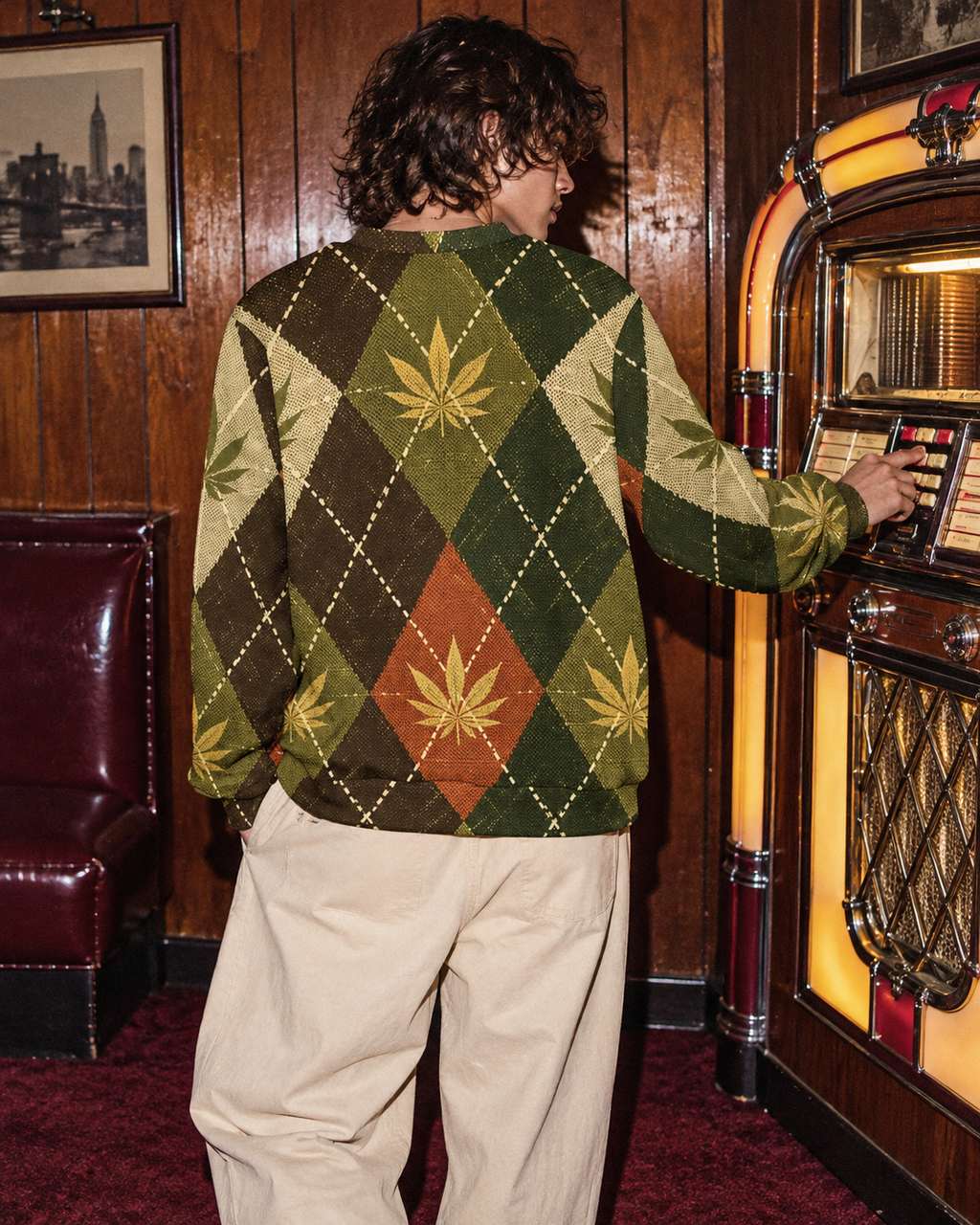 Back of botanical argyle crewneck beside a vintage jukebox