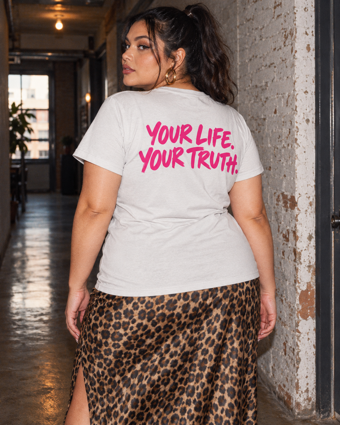 Back slogan on the BE JANE DOPE tee styled with a leopard skirt.
