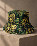 Jane Dope Big Buds Bucket Hat, front view showing green and yellow botanical print, black eyelets and stitched brim