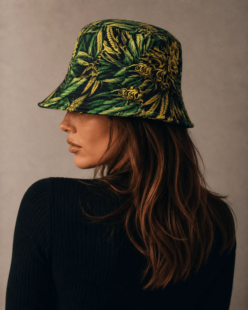 Jane Dope Big Buds Bucket Hat, side profile on a model showing sloping brim and green and yellow print