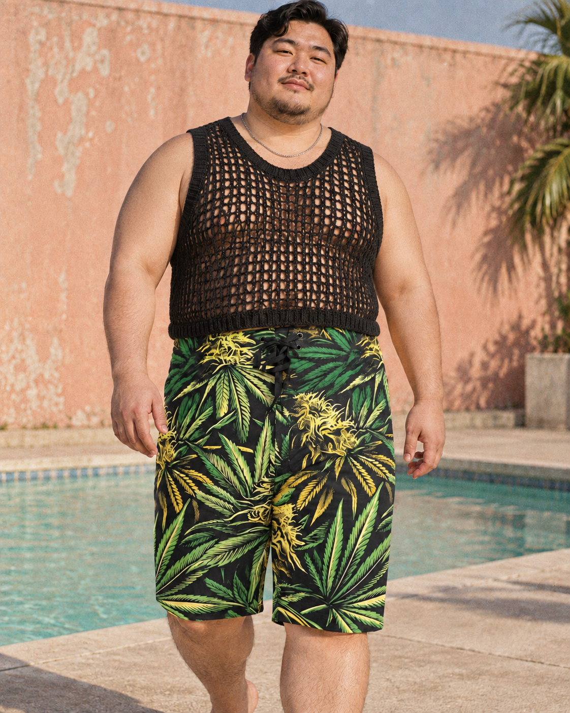 Big Buds men's green and yellow botanical board shorts styled with black open-knit vest.