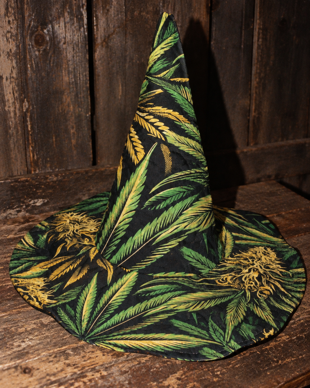 Big Buds botanical witch hat on barn wood, direct-flash front view with creased quilted fabric.