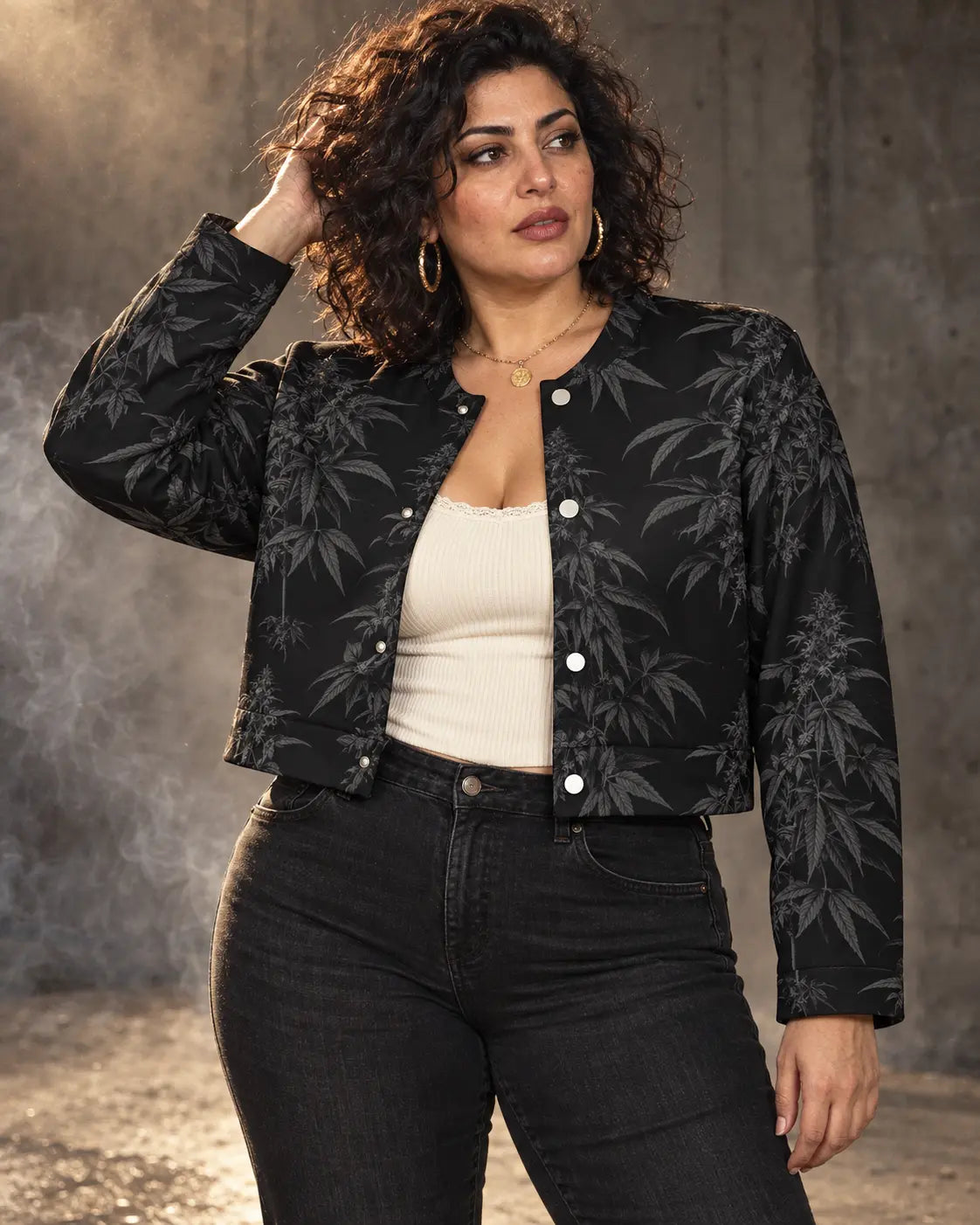 Black Widow cropped jacket worn over a cream tank and black jeans, with one hand lifting hair clear of the shoulder.