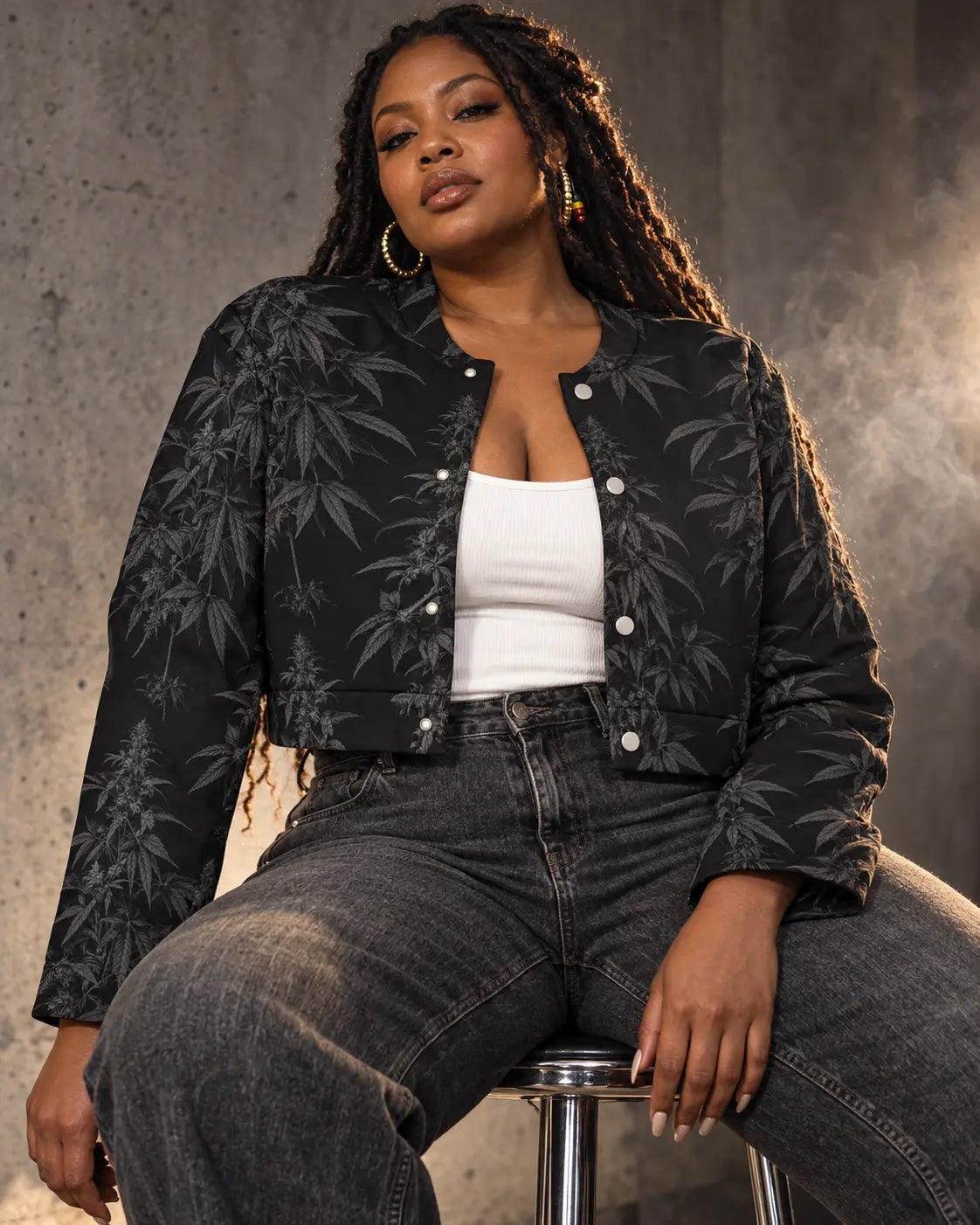 Black Widow cropped jacket on a seated model with locs, styled with a white tank and washed black jeans.
