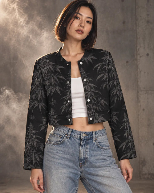 Jane Dope Black Widow cropped jacket with charcoal botanical print, worn over a white tank with loose denim in a smoky gray studio.