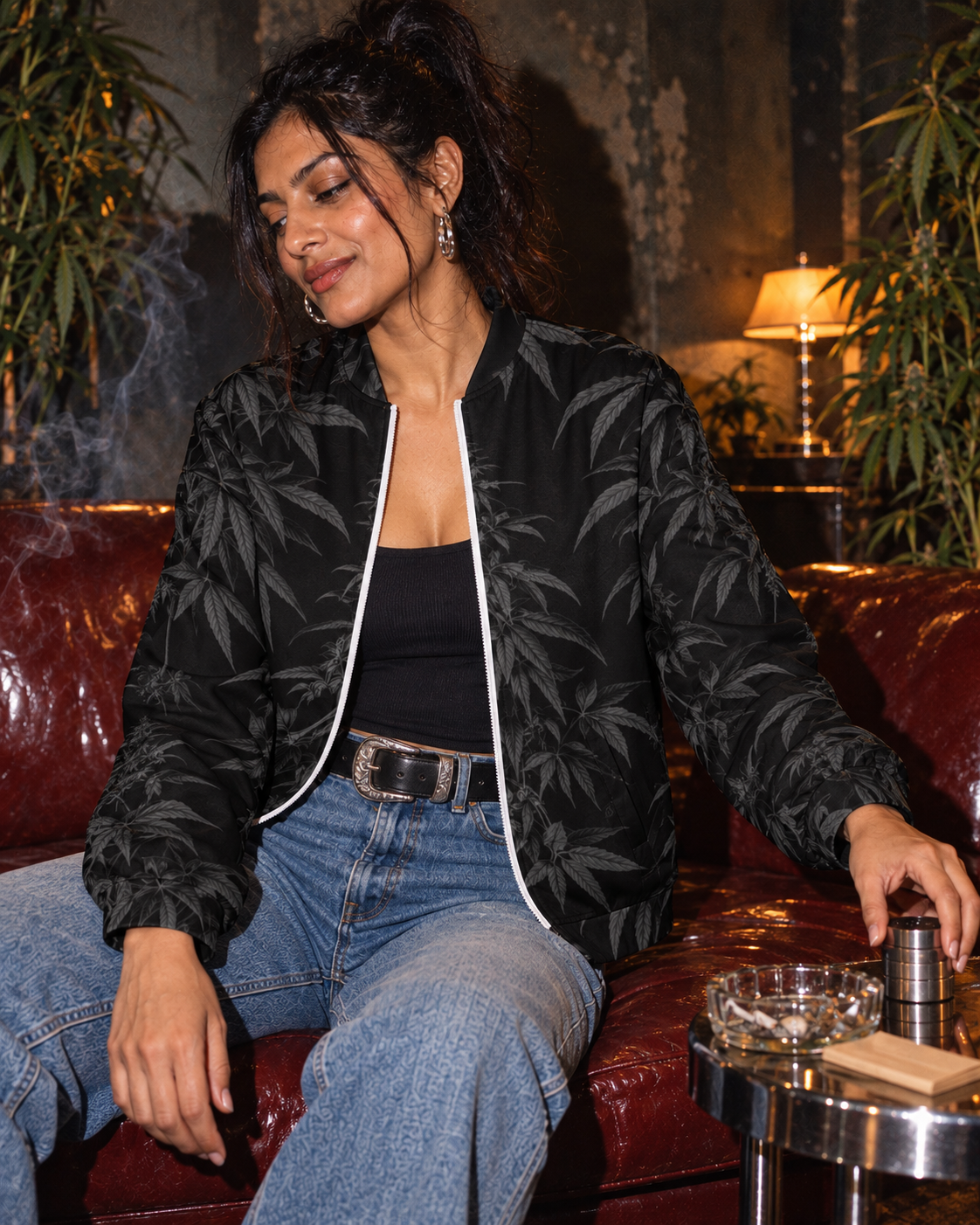 Black Widow jacket sleeve and cuff visible as a seated model reaches for a grinder on a chrome table.