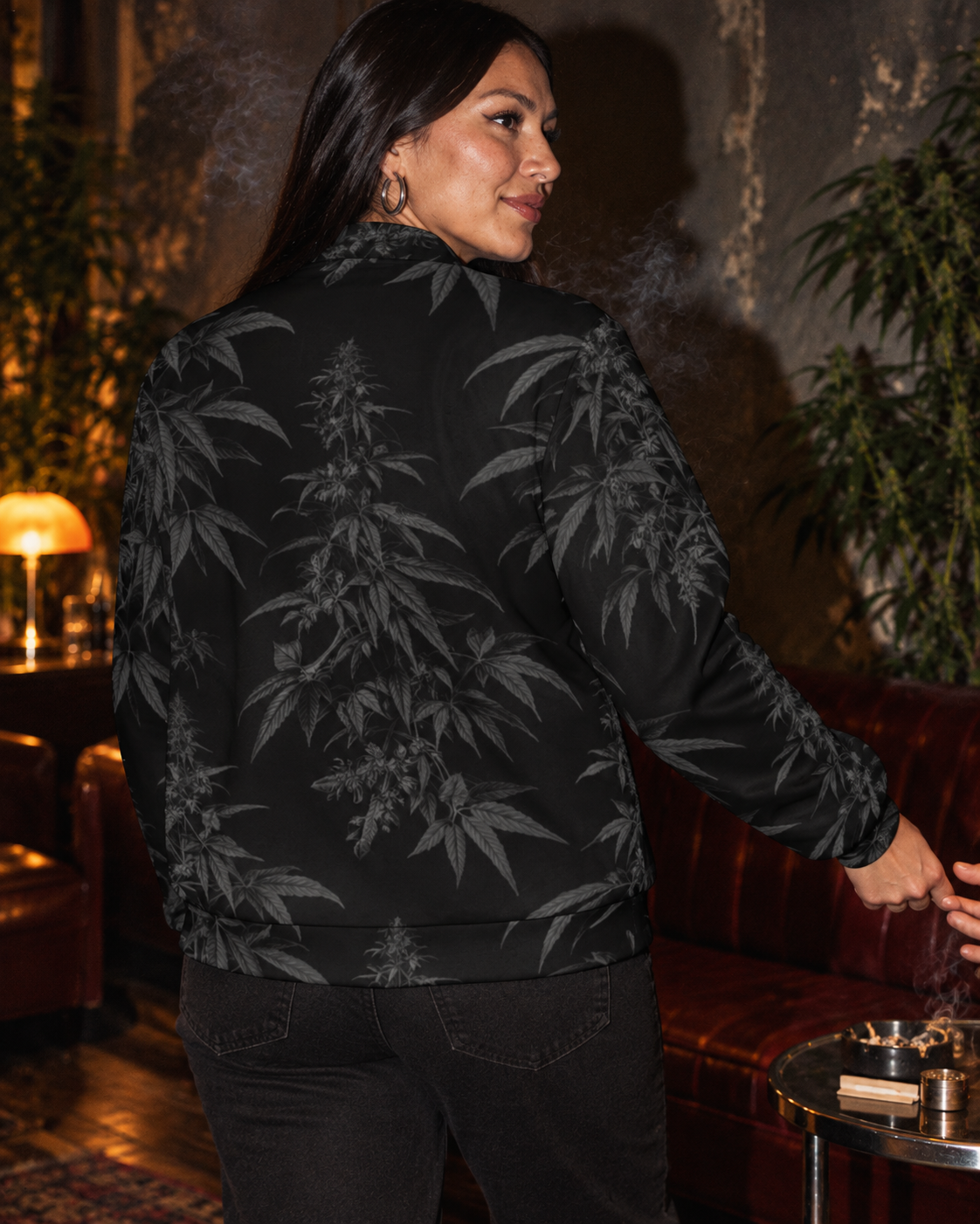 Rear three-quarter view of the Black Widow jacket, showing the stand collar and charcoal botanical branches.