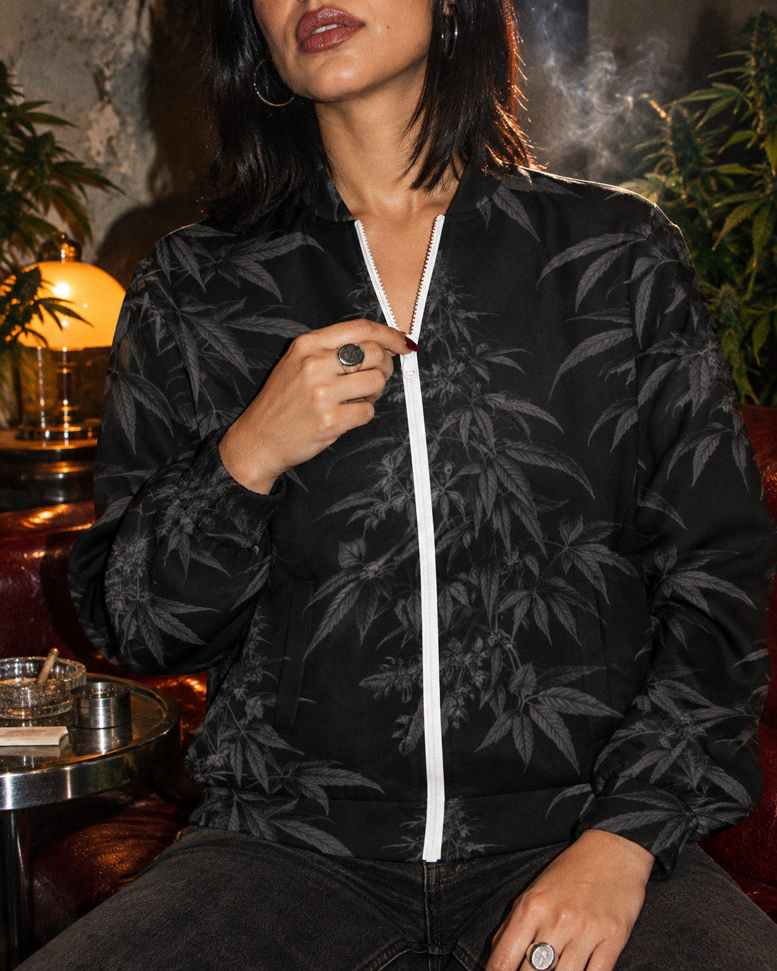 Close-up of the Black Widow jacket’s white zipper, stand collar and charcoal botanical print.