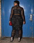 Back view of the Black Widow botanical mesh top and skirt with silver boots against a blue door.