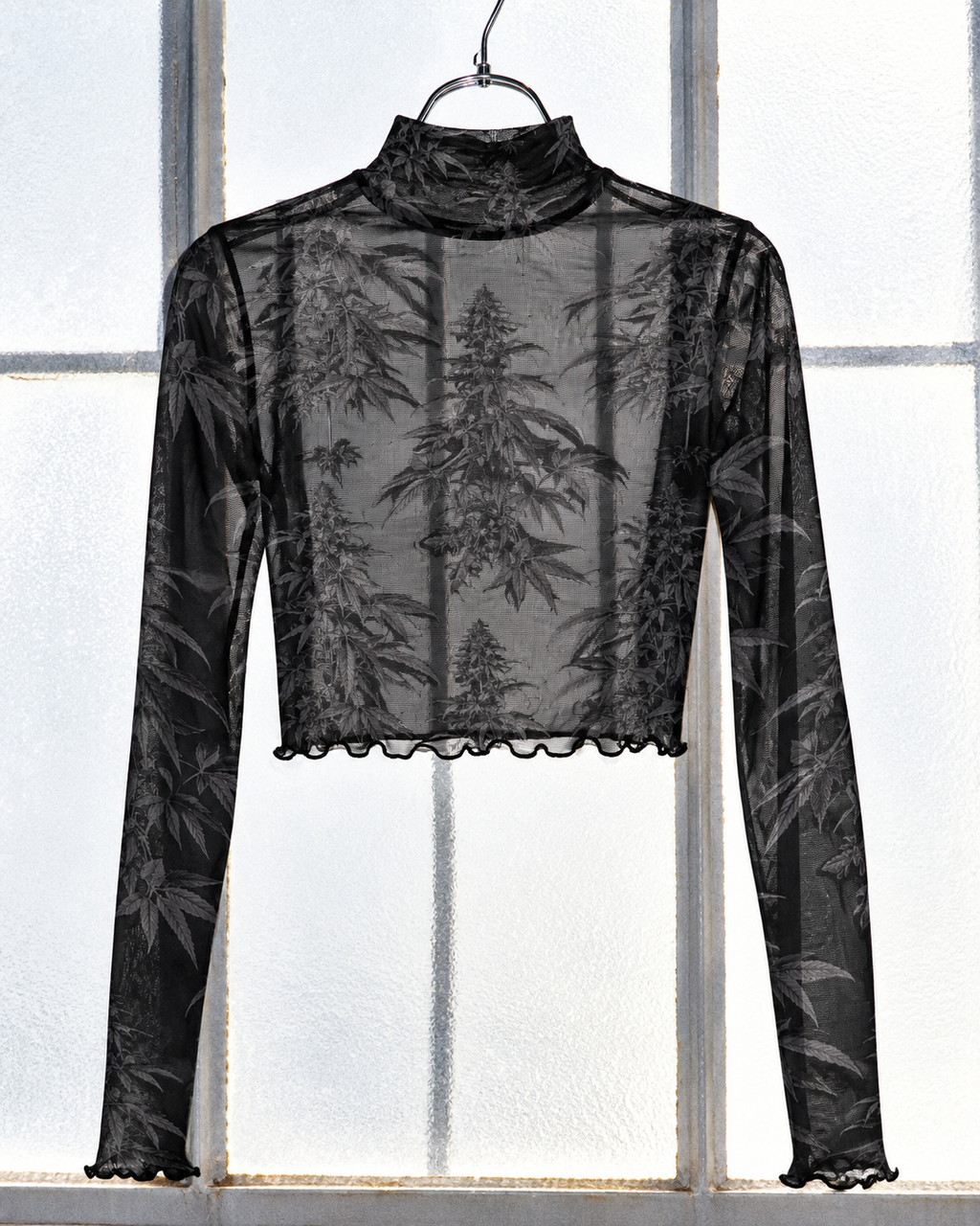Black Widow high-neck mesh crop top backlit at a window to show the unlined sheer fabric.