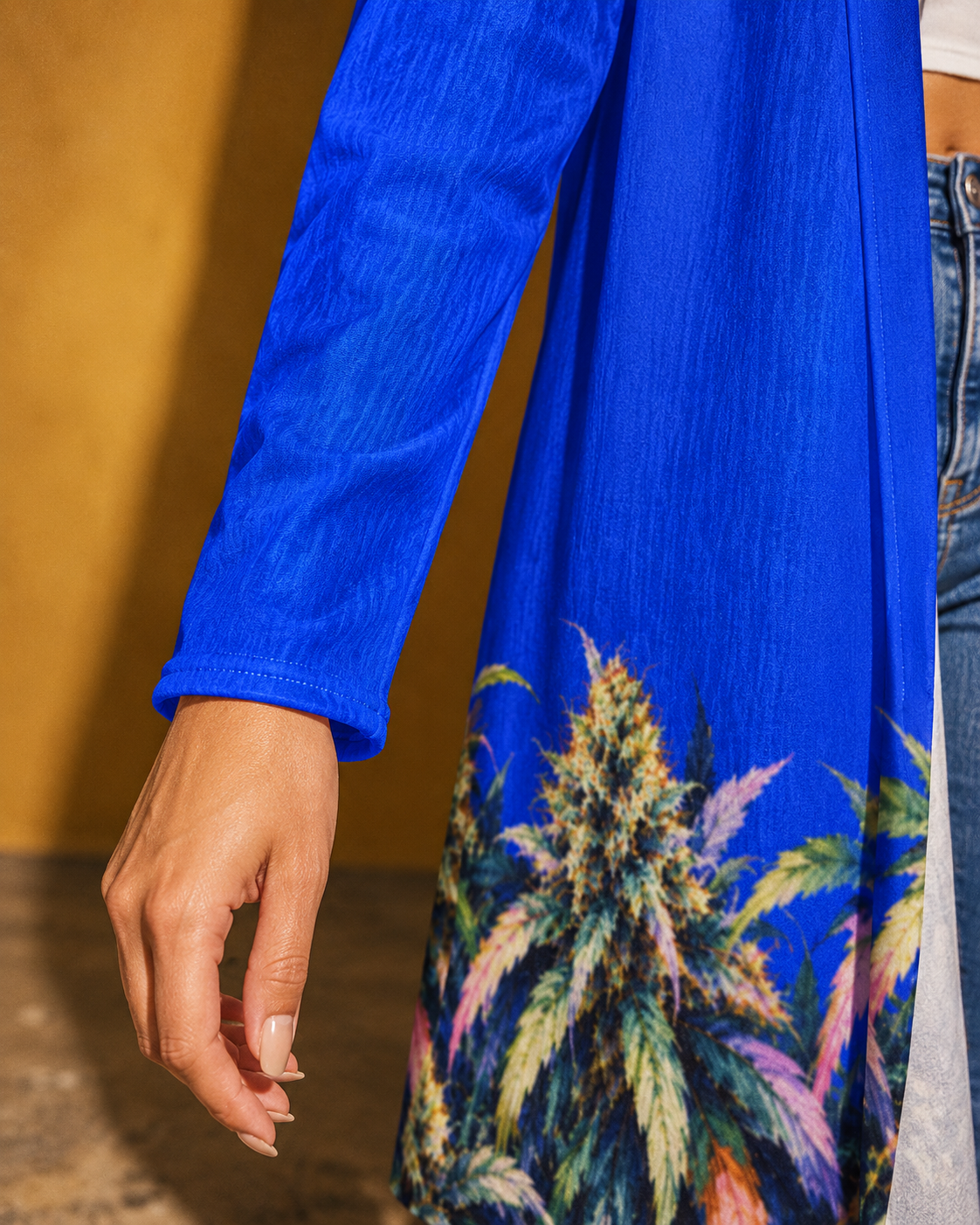 Close-up of the Blue Mazar blue sleeve hem and fine fabric texture beside the botanical print.