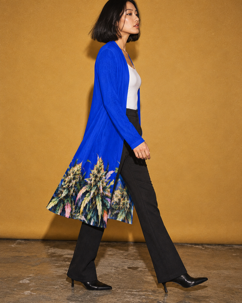 Side view of the Blue Mazar open-front cardigan in motion, styled with black trousers.