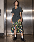 Blue Mazar charcoal botanical shirt dress, front editorial view with battered silver elevator doors.