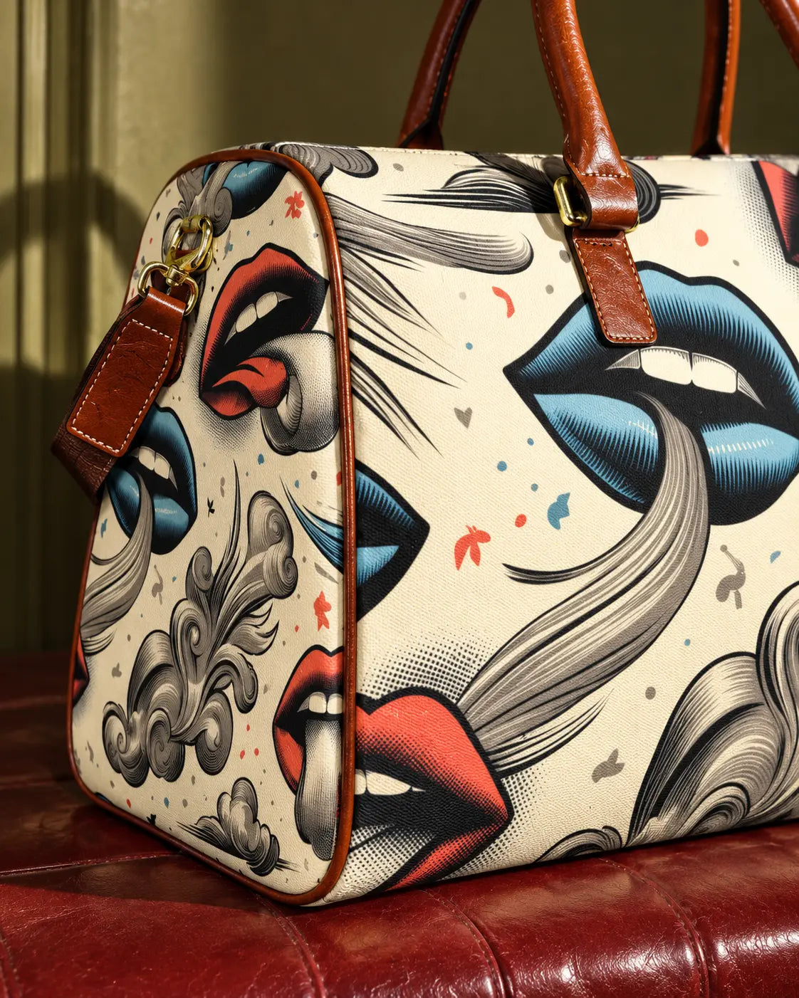 Close-up of Boujie XL bag print, brown piping, handle stitching and gold-tone strap clip.