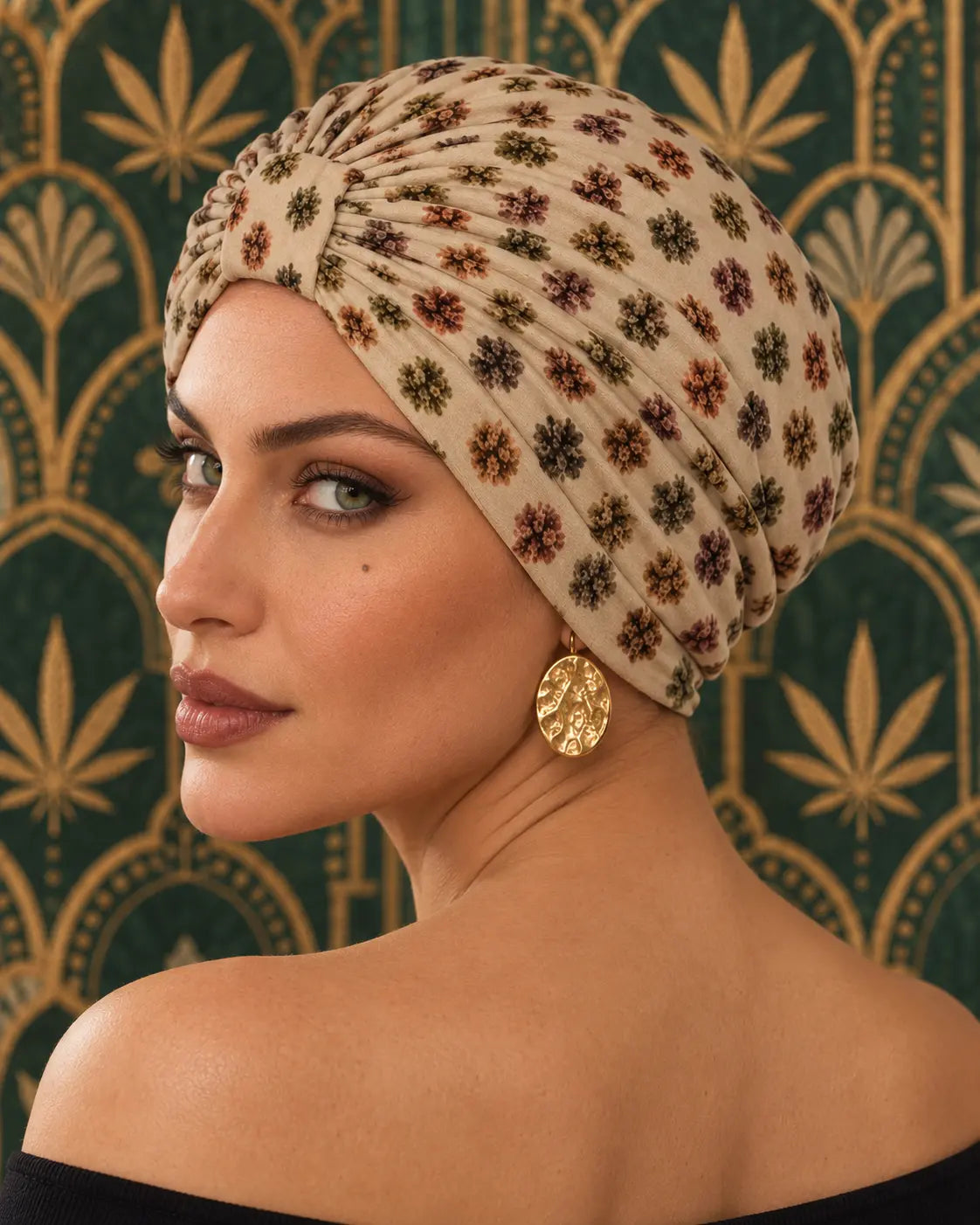 Bud Dots Turban Cap over-shoulder portrait showing the side drape and bud print with gold earrings.