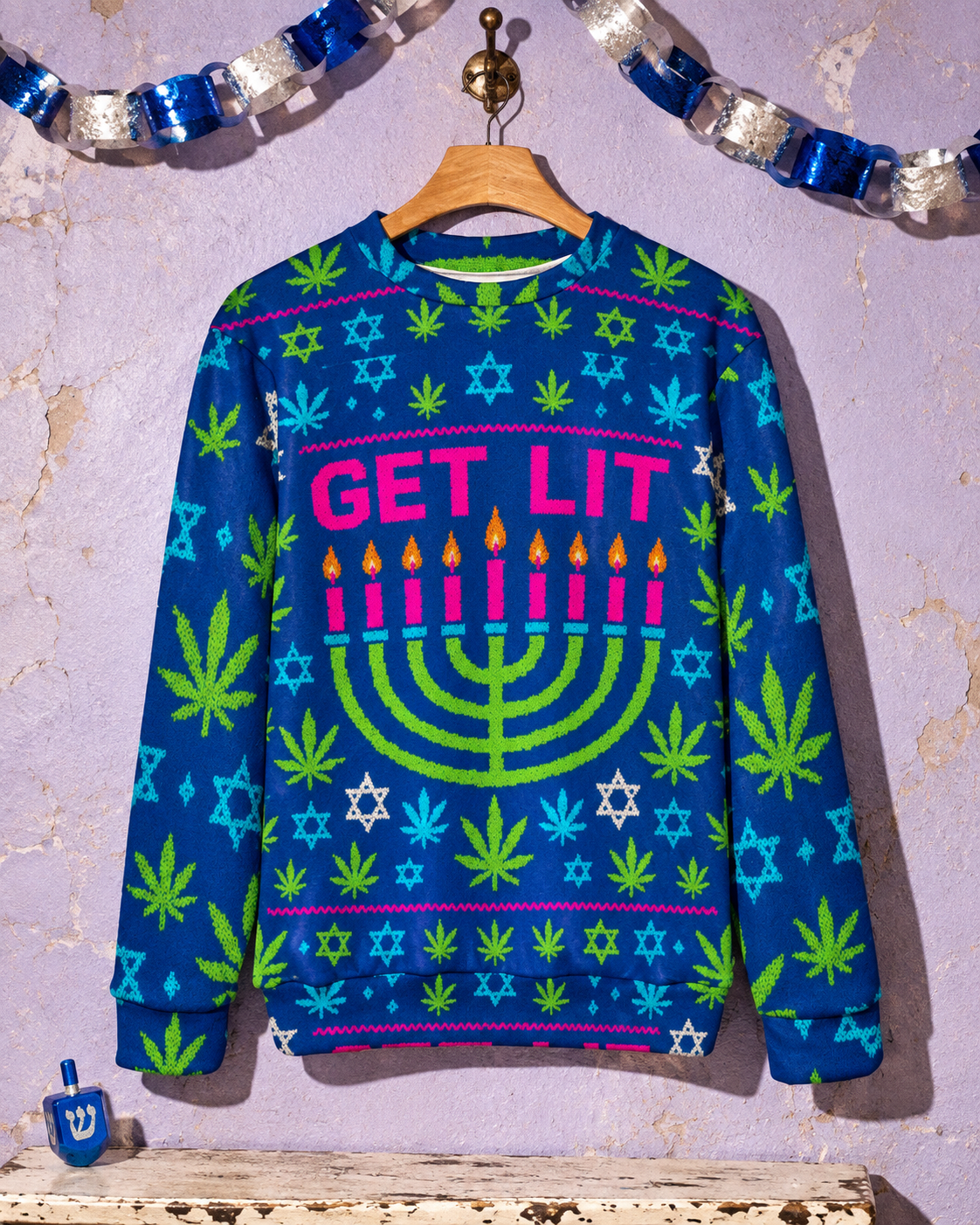 Front view of the blue Get Lit Hanukkah sweatshirt with pink lettering, a green menorah, Stars of David and Herb motifs.