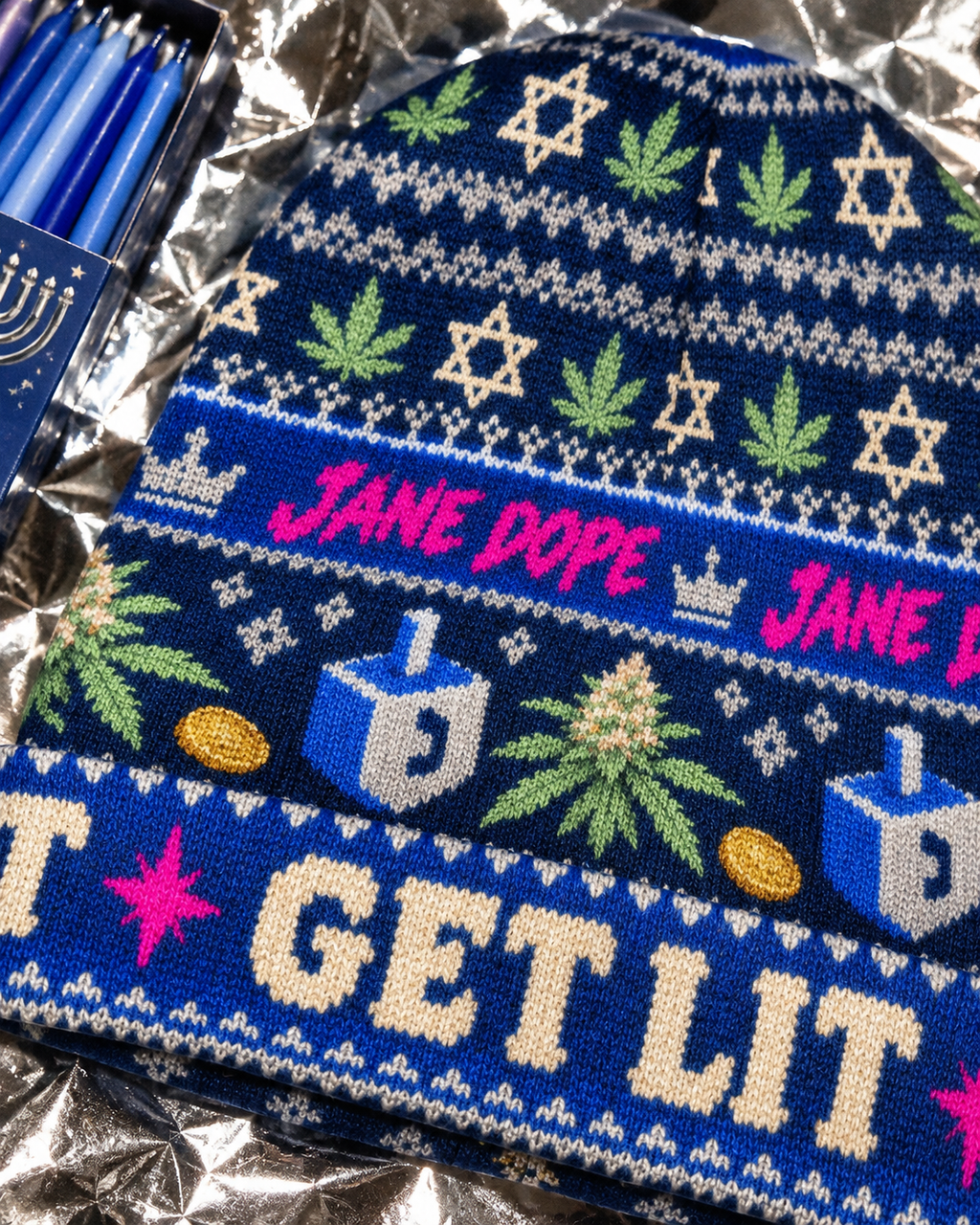 Close-up of the Get Lit cuff and hot-pink Jane Dope lettering on the Hanukkah beanie