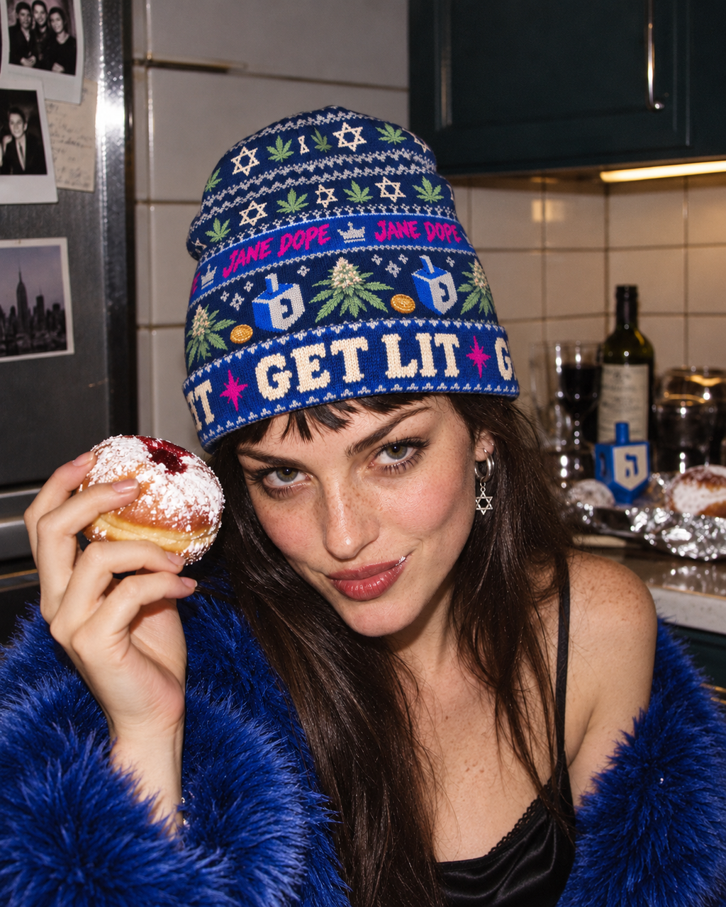 Get Lit Hanukkah beanie worn with cobalt faux fur in a playful doughnut portrait