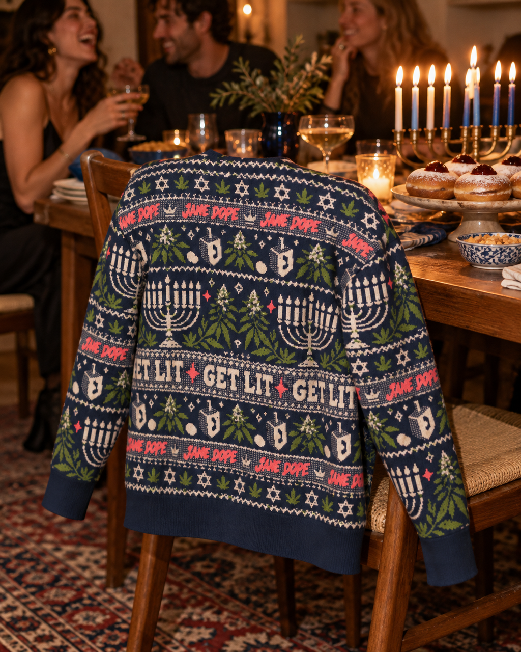 Get Lit cardigan back draped over a dining chair beside a Hanukkah table.
