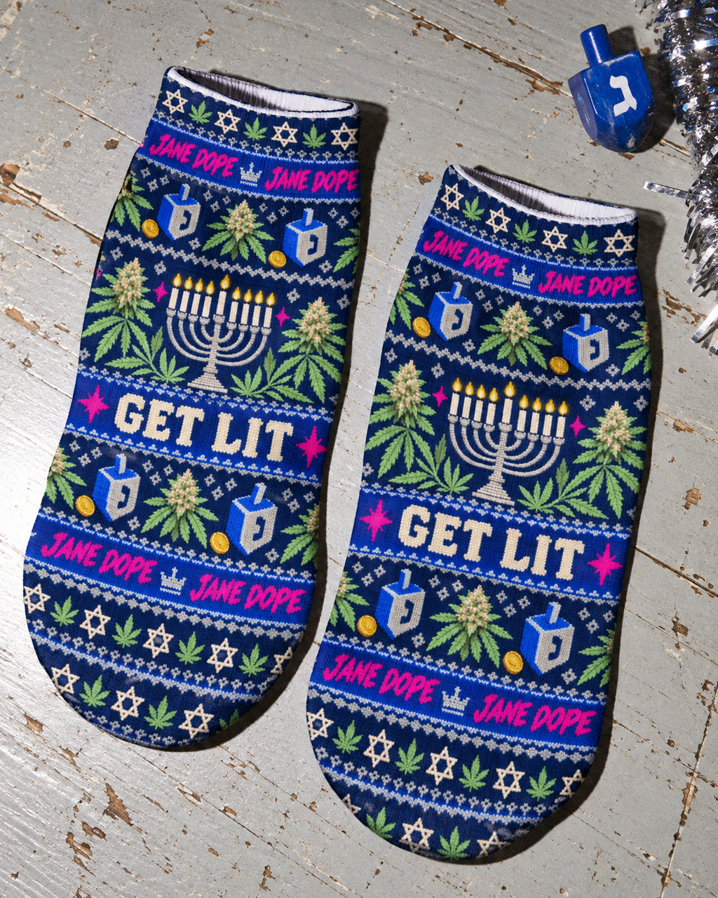 Get Lit Hanukkah ankle socks pair showing the navy all-over print, dreidels and pink Jane Dope lettering.