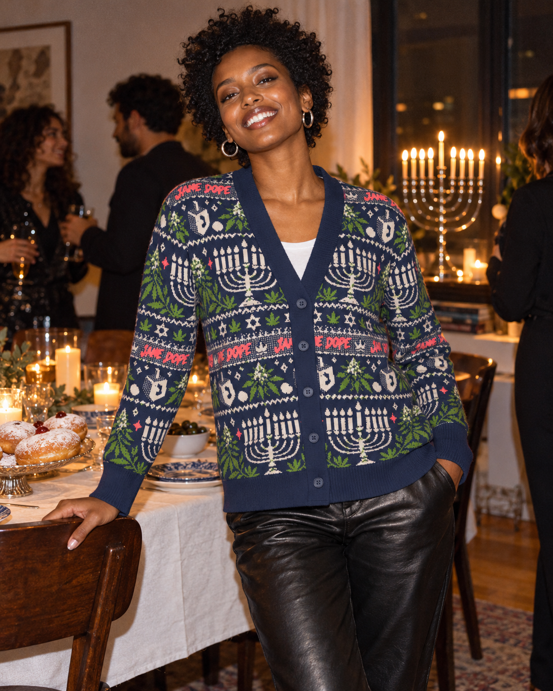 Get Lit navy knit cardigan with black leather trousers at a candlelit Hanukkah party.