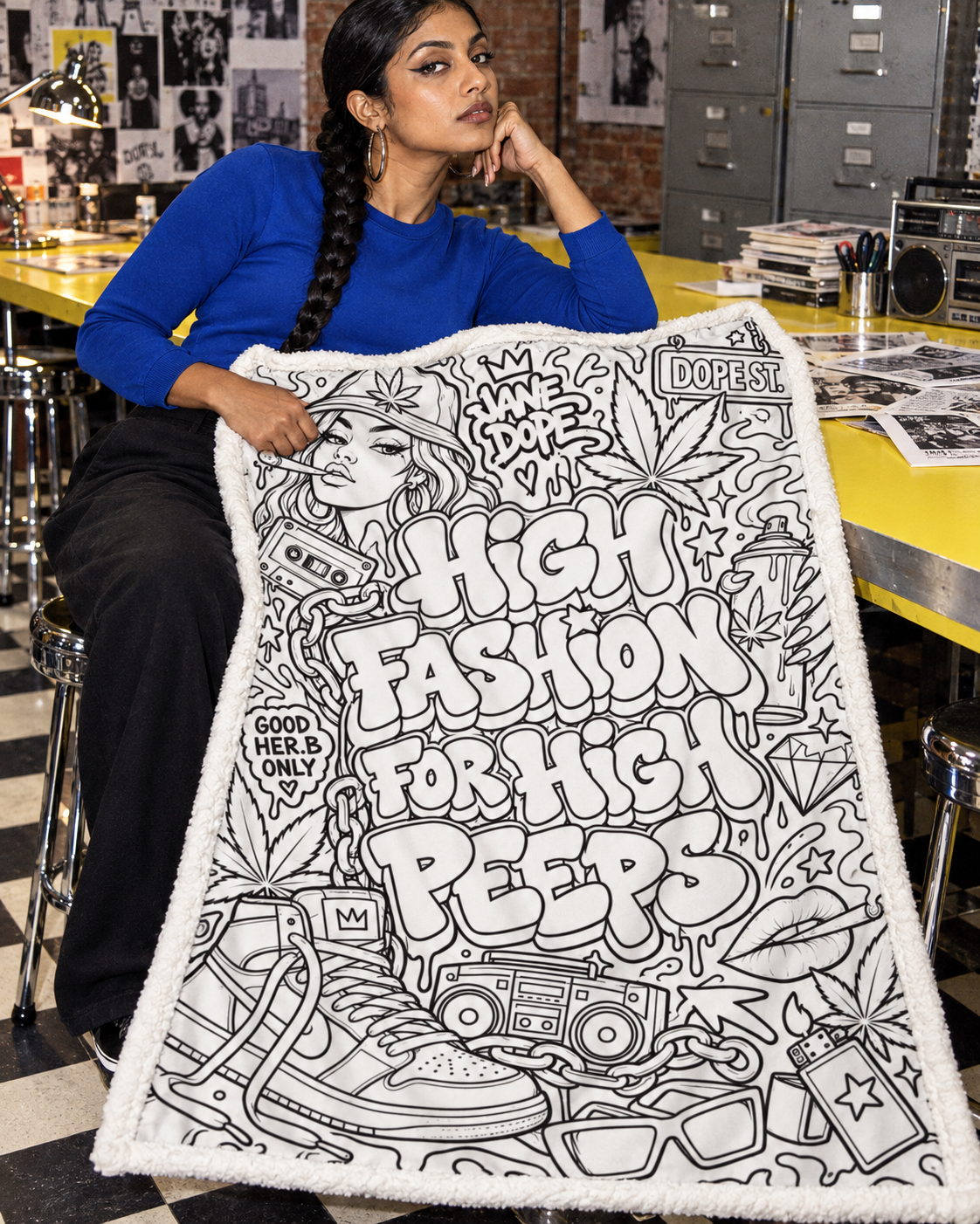 Adult model with the uncoloured High Fashion blanket across her lap, showing bold lettering and the fleece edge